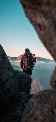 a man standing on top of a rocky cliff