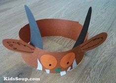 a paper crown made to look like an animal with scissors in it's mouth