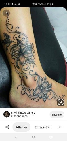 a tattoo is shown on the foot of a woman