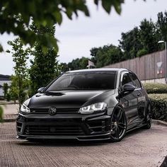 a black car parked on the side of a road