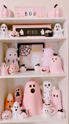 a shelf filled with lots of fake ghost figurines on top of white shelves