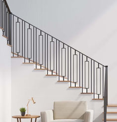 a white chair sitting under a stair case next to a table with a potted plant