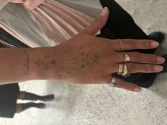 a woman's hand with tattoos on it