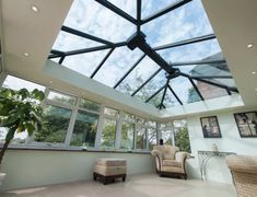 a living room filled with furniture under a skylight