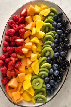 a plate full of fruit with the title overlay that reads, how to make a rainbow fruit tray