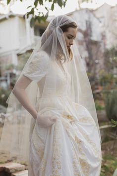 a woman wearing a wedding dress and veil