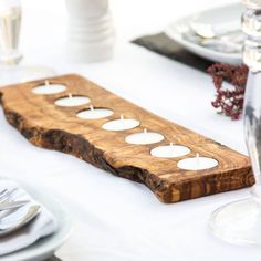 a wooden table with white candles on it