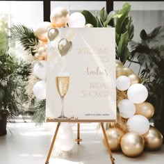 a welcome to another bridal shower sign next to balloons and greenery in the background