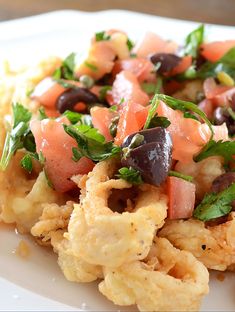 a white plate topped with an assortment of food on top of it's side