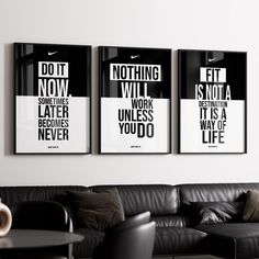 three black and white posters hanging on the wall above a couch in a living room