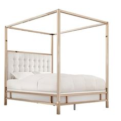 a white bed with a metal frame and headboard