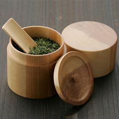 three wooden containers with herbs in them on a table