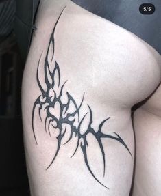 a woman's thigh with a tattoo design on it