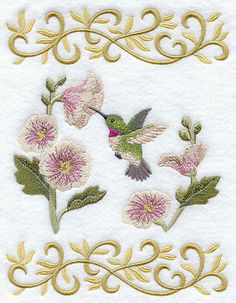 a white towel with embroidered flowers and a hummingbird flying over the top of it