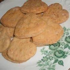 some cookies are on a white plate with green flowers