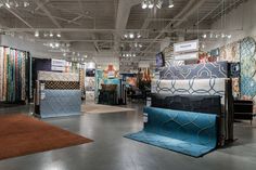 a room filled with lots of different types of rugs and floor coverings on display