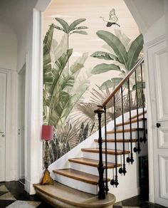 a staircase with tropical wallpaper on the walls