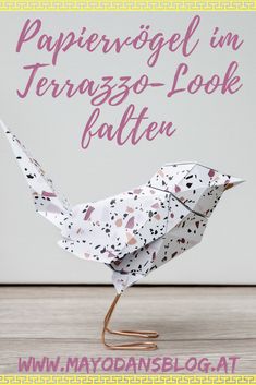 an origami bird with the words papierogel im terrazzo - look pattern