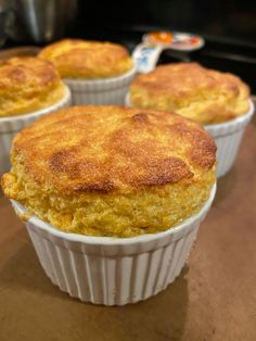 several baked food items in white dishes on a table