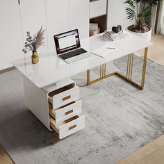 a laptop computer sitting on top of a white desk next to a potted plant