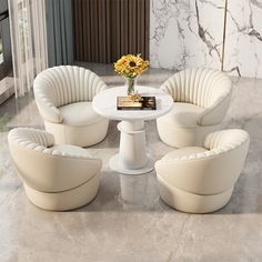 a white table with four chairs and a vase on it in front of a marble wall