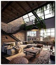 a living room filled with lots of furniture and plants hanging from the ceiling above it