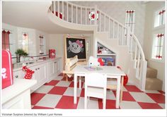 a kitchen with red and white checkered flooring next to a spiral stair case