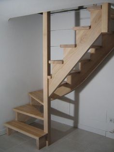 there is a wooden stair case next to the wall