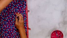 a woman is working on a piece of fabric with scissors and a pair of pink slippers