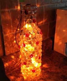 a lighted bottle sitting on top of a counter