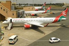 several airplanes are parked on the tarmac at an airport with luggage carts and vehicles around them