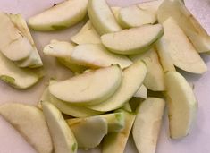 sliced apples sitting on top of a cutting board