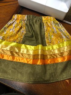 "18-24 months Child's ribbon skirt with golden ash and olive green cotton blend fabric. Waist 19\", length 13\" width 36\". Many blessings!" Green Cotton Dress With Lined Skirt, Ribbon Skirt, Baby Girls Dresses, Ribbon Skirts, Ribbon Dress, Ribbon Shirt, Green Cotton