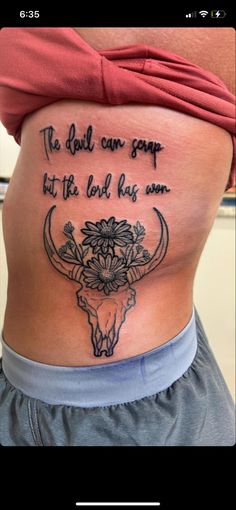 a woman with a tattoo on her stomach that says, the devil can soap but the lord has son