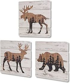 three pieces of wood with an image of a moose and bear on it's side