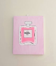 a painting of a pink chanel bottle on a white wall