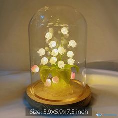 a glass dome with flowers in it on a wooden base