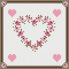 a cross stitch heart with pink roses on it