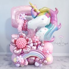 a balloon shaped like a unicorn with flowers and balloons