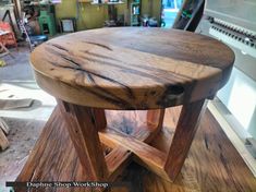 a wooden stool sitting on top of a table in a room filled with tools and other items