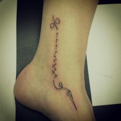 a woman's foot with a tattoo on it