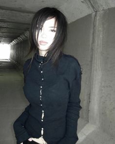 a woman standing in a tunnel with her hands on her hips