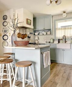 a kitchen with blue cabinets and wooden stools