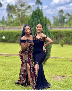 two women in dresses posing for the camera