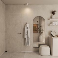 a bathroom with a sink, mirror and shelf on the wall next to a toilet