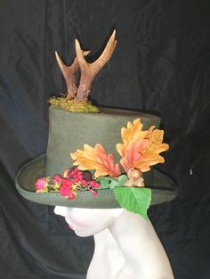 Straight from the woodlands, the hat for a faun , hand blocked in forest green wool with two roe deer horns bursting through the top, on the sides are fallen leaves, blackberries and raspberries . It has a proper wired brim covered with green millinery petersham ribbon and is trimmed with matching ribbon. Inside it has a hat  band to help secure it and is fully lined with  satin.  It is made to fit a 22 inch head . Winter Costume Hat With Short Brim For Country Events, Green Brimmed Felt Hat For Fall, Green Curved Brim Felt Hat For Fall, Green Felt Hat With Short Brim For Fall, Green Short Brim Felt Hat For Fall, Green Brimmed Hat For Fall, Green Wool Hat For Fall, Green Outdoor Hat For Fall, Brimmed Felt Hat For Winter Costume