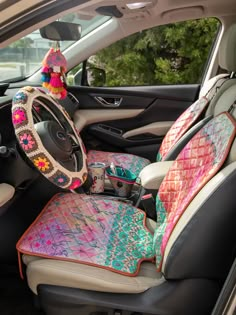 the interior of a car decorated with colorful pillows