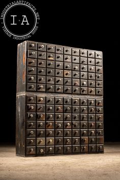 two large metal boxes stacked on top of each other in front of a black background