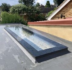 a large rectangular water feature on top of a roof