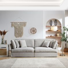 a woman sitting on top of a couch in a living room